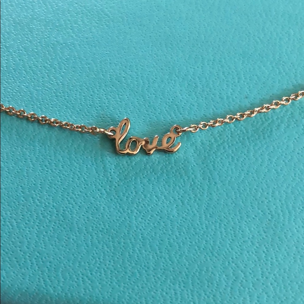“Love” pendant necklace on gold metal chain